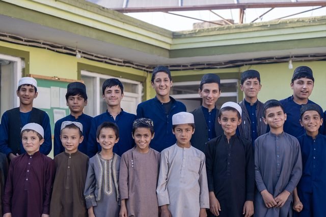 A group of children standing together outside